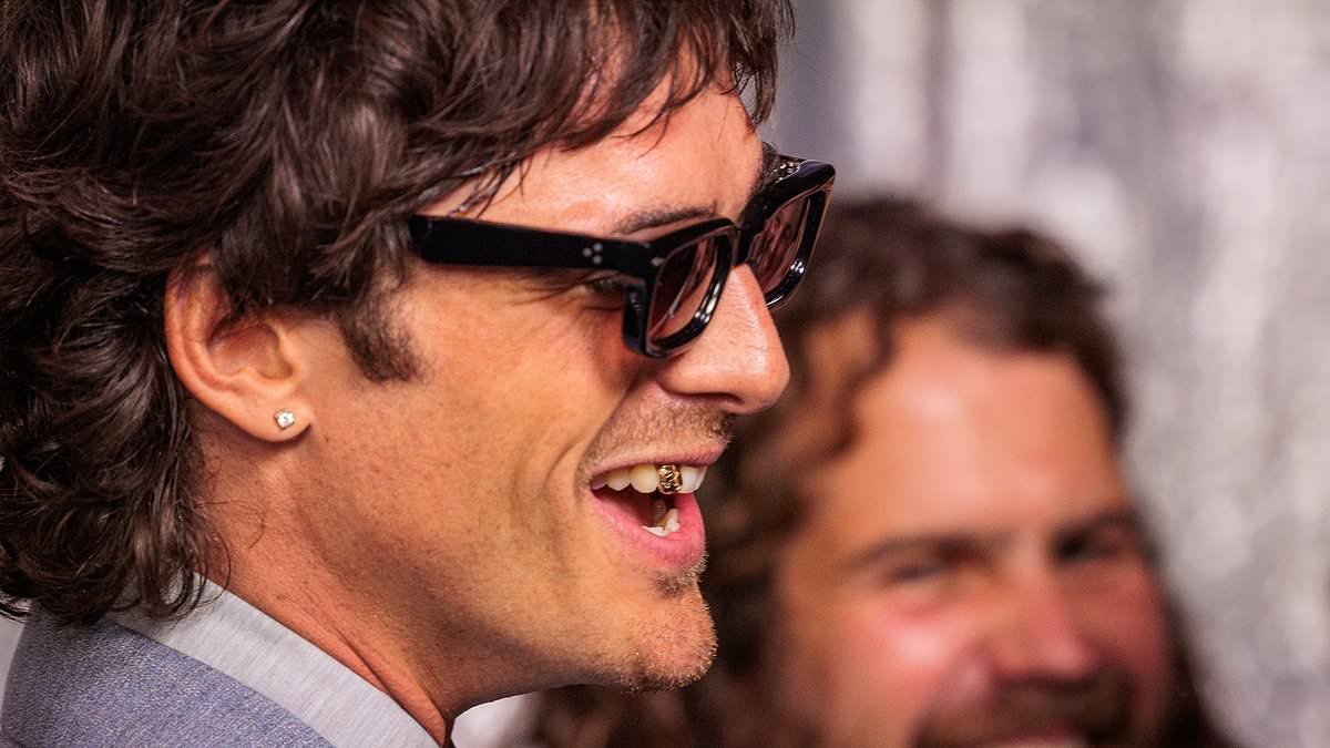 Jacob Elordi pays tribute to Heathcliff with a replica of the brooding anti-hero's gold tooth for Wuthering Heights' Sydney premiere