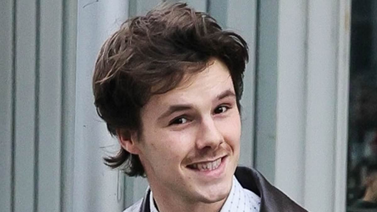 Cruz Beckham rocks an 80s car salesman look while promoting new single with girlfriend Jackie Apostel - as fans praise track as 'the perfect  cross between the Beatles and Oasis'