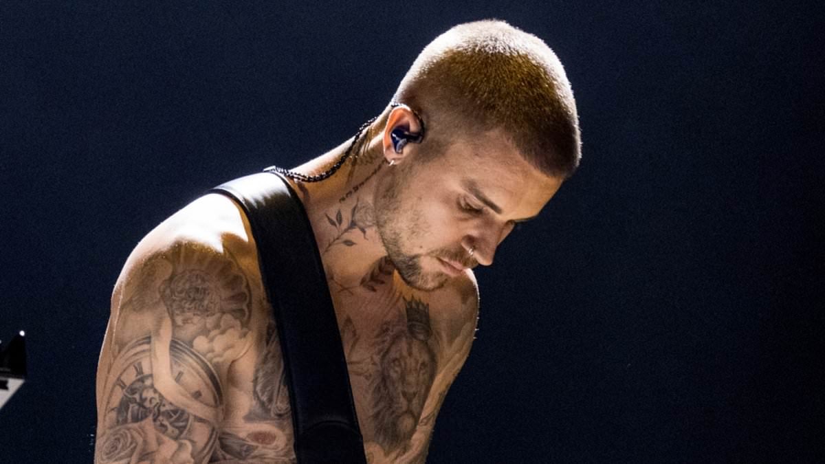 Shirtless Justin Bieber debuts huge tattoo of his wife Hailey's face during Grammys performance of Yukon - as fans claim it bares striking similarity to one of ex Selena Gomez