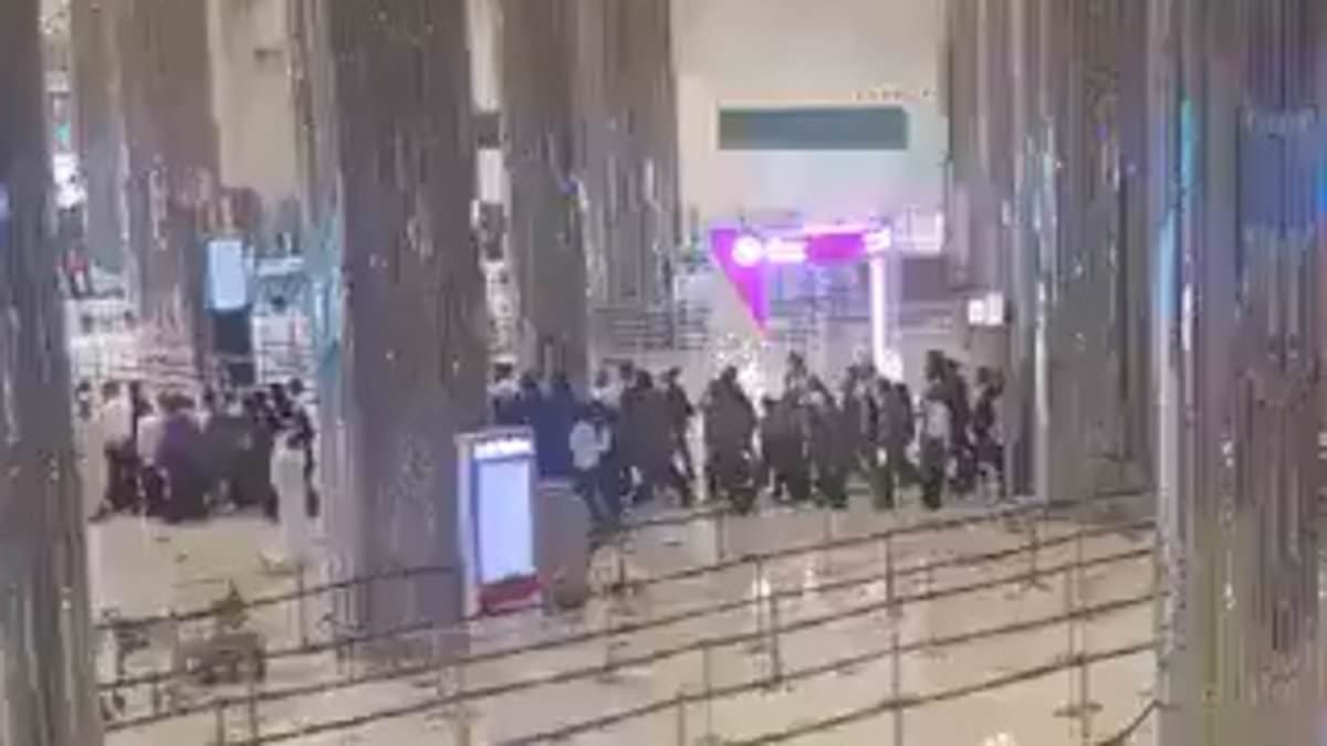 Panic at Dubai Airport as 'it is hit by an Iranian suicide drone' and passengers flee wrecked terminal
