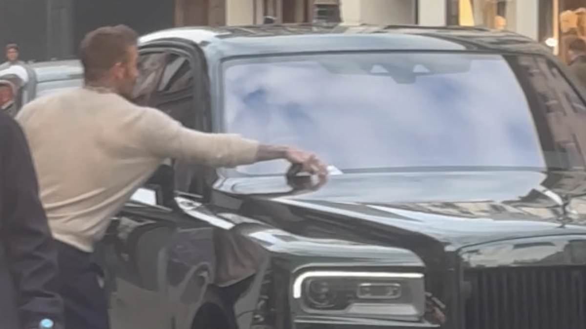 David Beckham rips a parking ticket off the windscreen of his swanky £160k Bentley after shopping spree at Rolex on Bond Street with wife Victoria