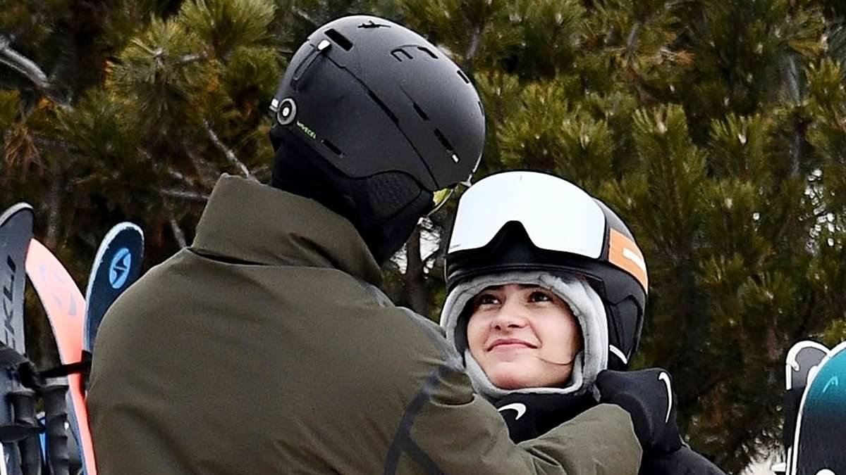 A piste of his heart: Romeo Beckham and girlfriend Kim Turnbull look smitten as they cuddle up on the slopes as he takes his mind off family feud with brother Brooklyn on a ski holiday in the Dolomites