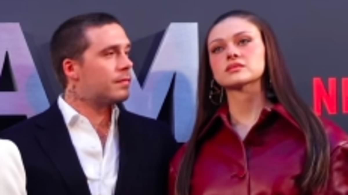 Notorious clip of stony-faced Nicola Peltz being pulled into a Beckham family picture goes viral after her husband Brooklyn's explosive online statement