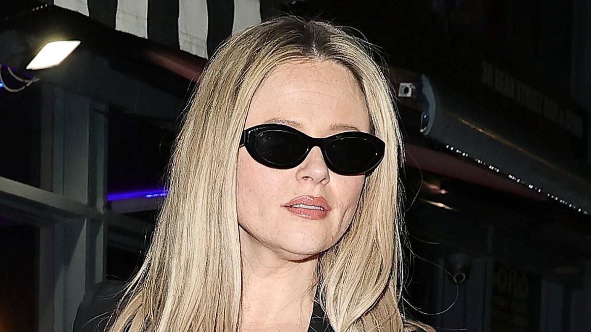 Emily Atack flashes a glimpse of her lingerie in a plunging suit as she leaves her Agent Provocateur dinner with fiancé Alistair Garner