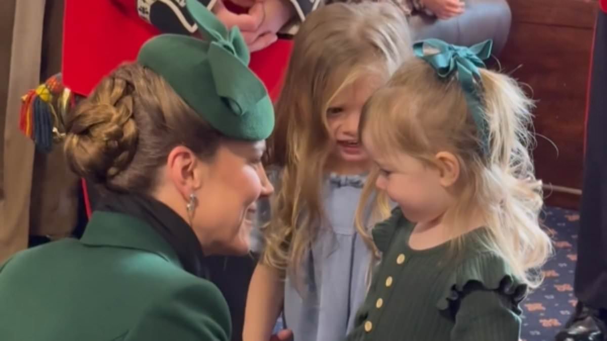 Jumping for joy with Kate! Princess lifts excited 3-year-old daughter of Irish Guards soldier into the air before holding hands and sharing VERY animated faces