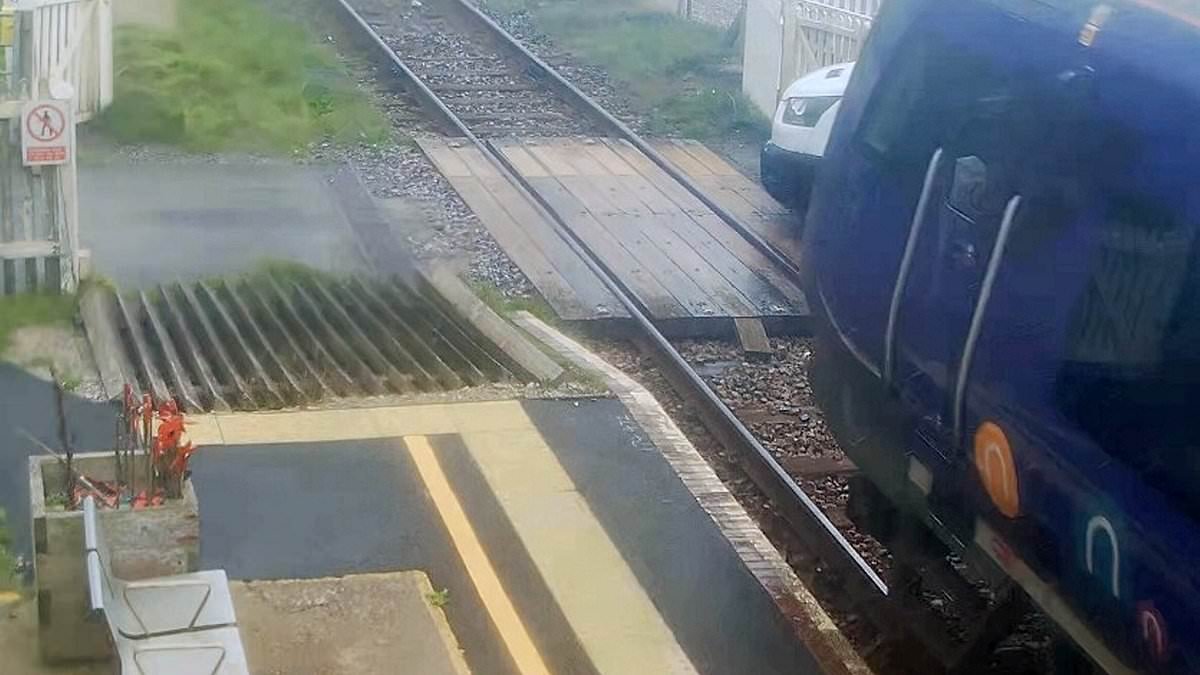 Moment train smashes into van when delivery driver pulled onto level crossing after opening gates by hand