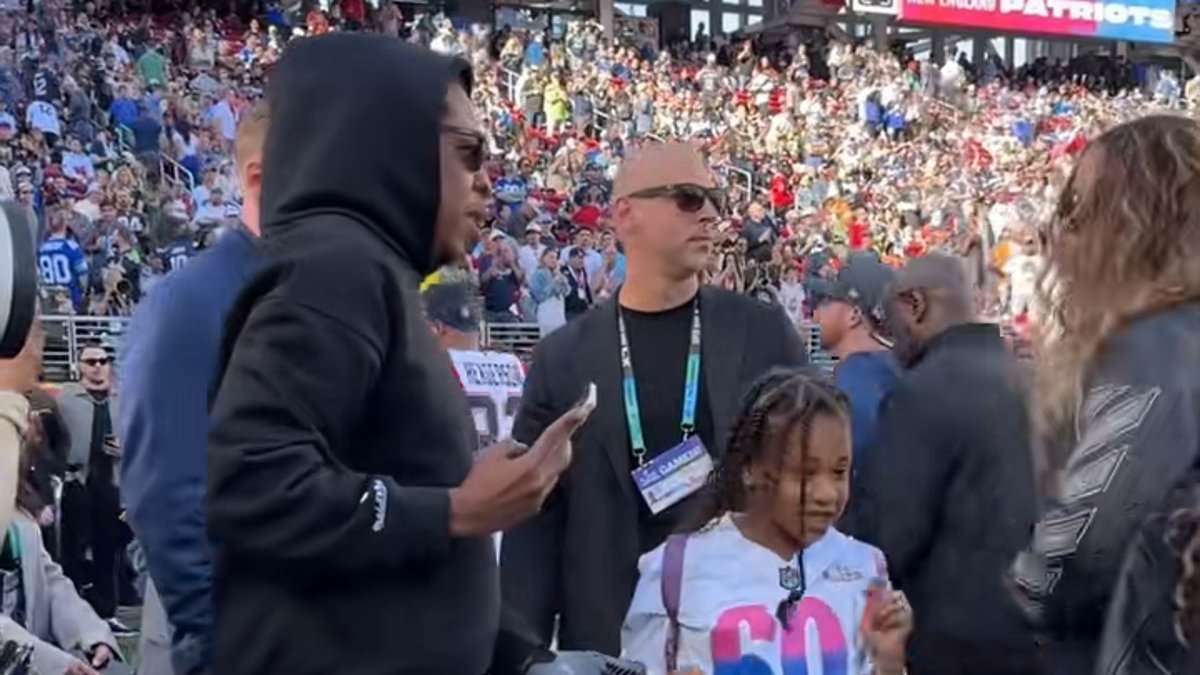 Jay-Z and Beyonce's youngest daughter Rumi runs riot at the Super Bowl before being wrangled by bodyguard
