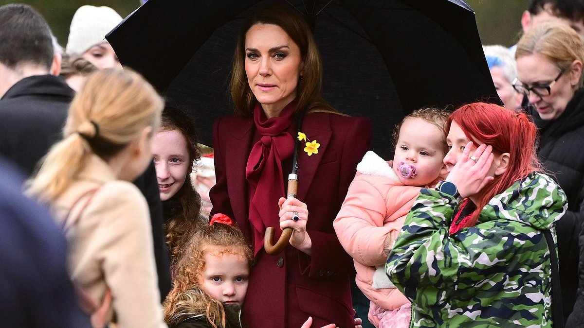 Her royal hugness! Kate gets a cuddle from an adorable young royal fan who doesn't want to let go of the Princess on visit to Wales