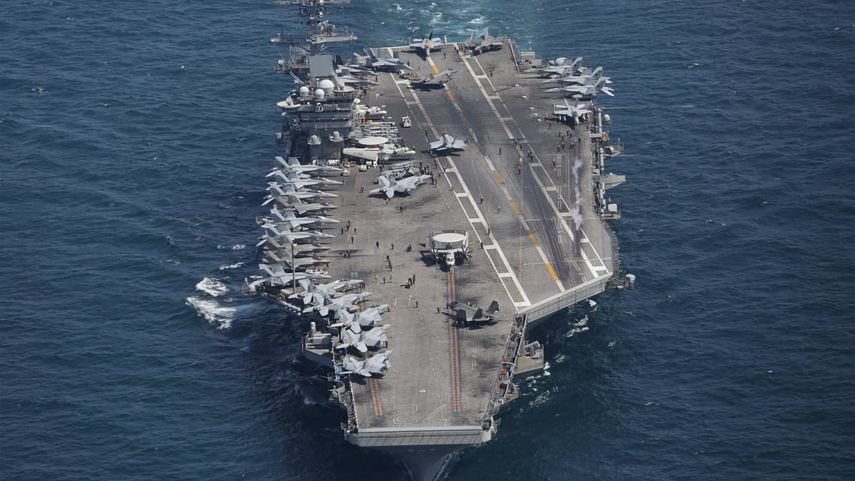 Iran claims 'attack' on US aircraft carrier as Tehran's navy chief shares 'footage of missile strike' on £1.8billion warship in Arabian sea