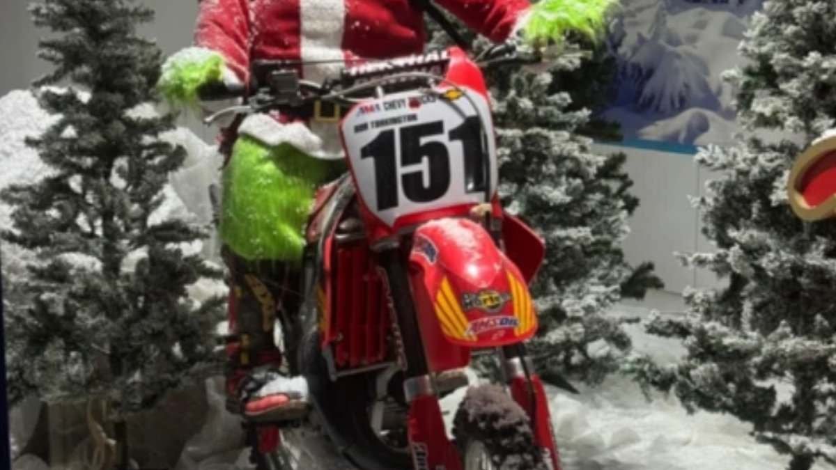 Thugs who stole Christmas: Moment thieves are caught on CCTV stealing motorbikes from garage's Grinch display