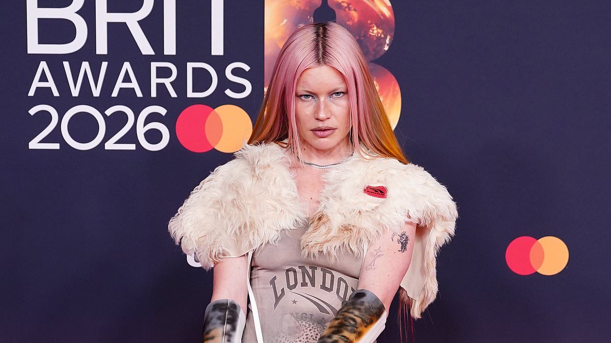 Wet Leg's Rhian Teasdale arrives at the BRIT Awards with bloodied knees as she makes a bizarre red carpet appearance