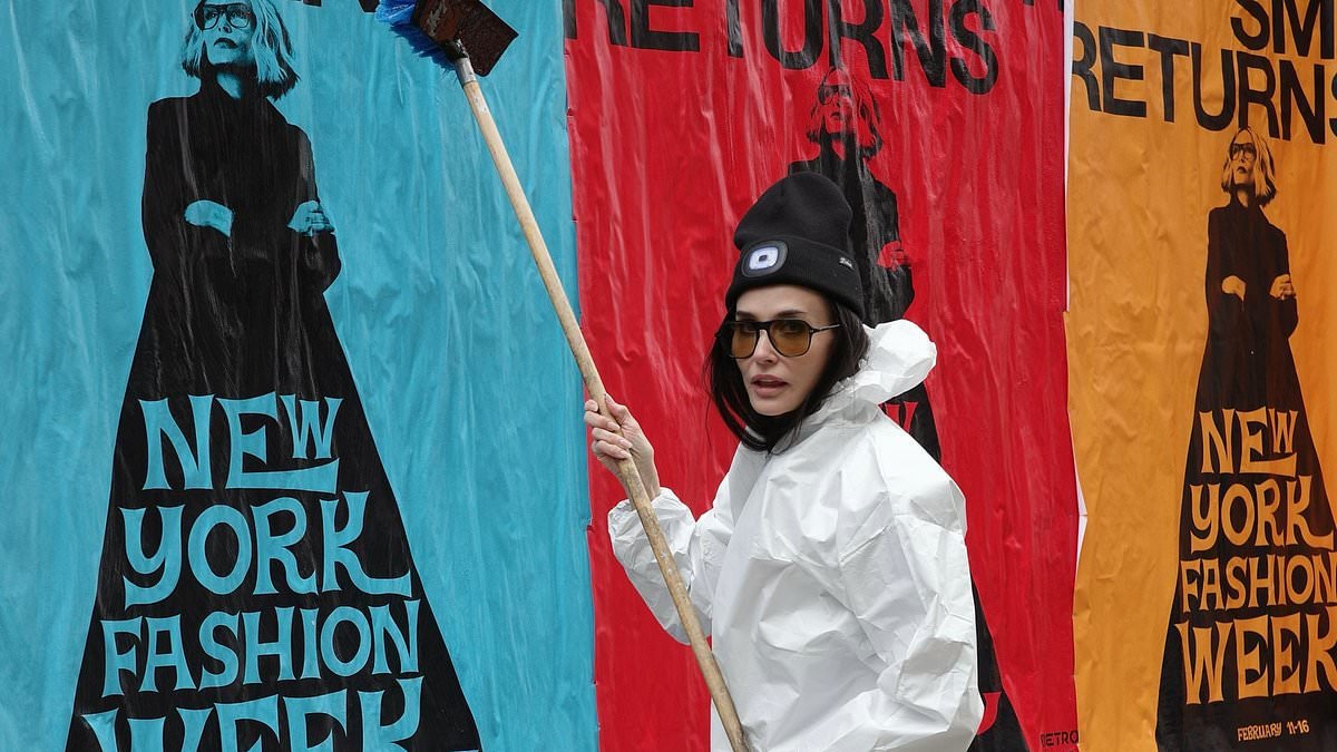 Demi Moore looks a million miles from her glamorous self as she dons a hazmat suit to stick up posters for her new movie in NYC