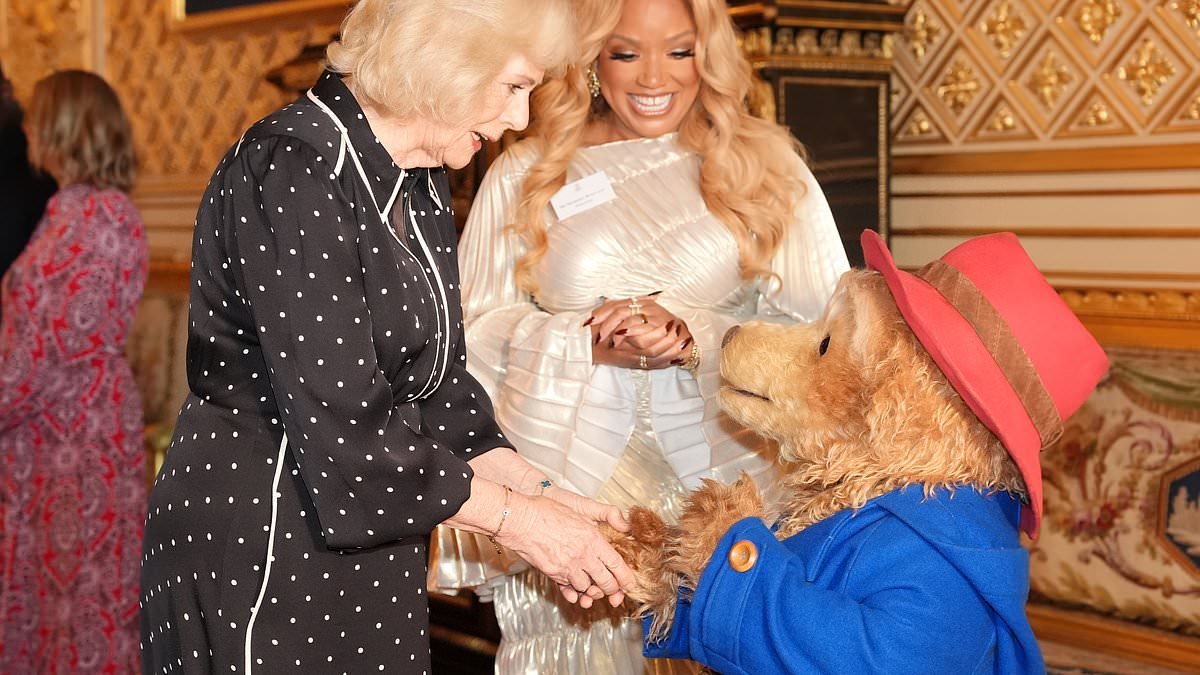 Paddington at the palace! Queen is introduced to everyone's favourite bear as she hosts reception for young writers
