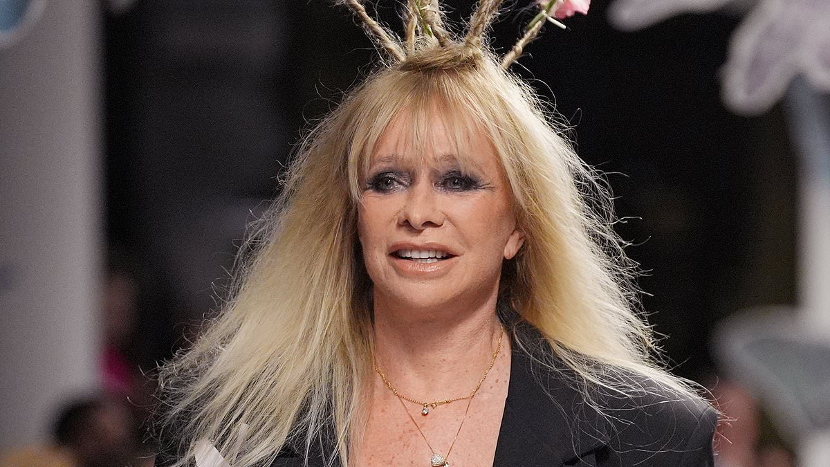 Jo Wood, 70, turns heads as she struts down the runway in a lace bra and power suit for Vin+Omi's London Fashion Week show