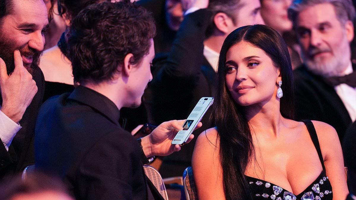 Timothee Chalamet spends the BAFTAs texting on his phone as he is sent a meme of himself after host Alan Cumming instructed the audience to 'turn off all electronic devices'