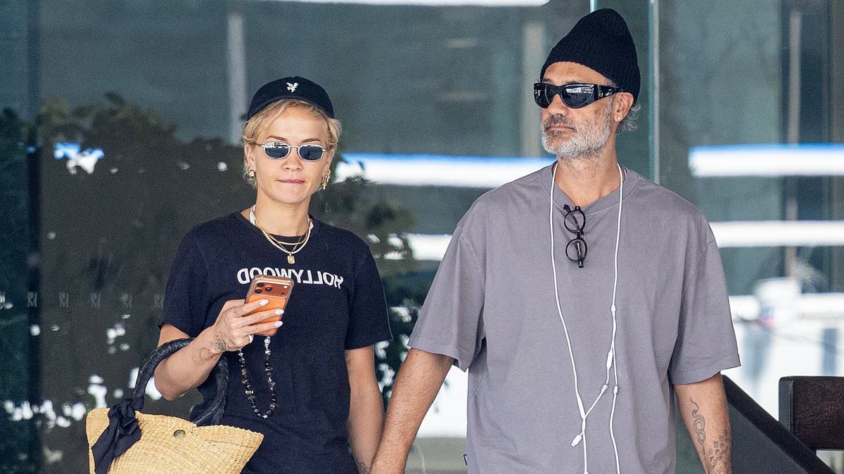 Rita Ora, 35, puts on a leggy display in skimpy shorts as she enjoys a romantic stroll hand-in-hand with husband Taika Waititi, 50, in LA