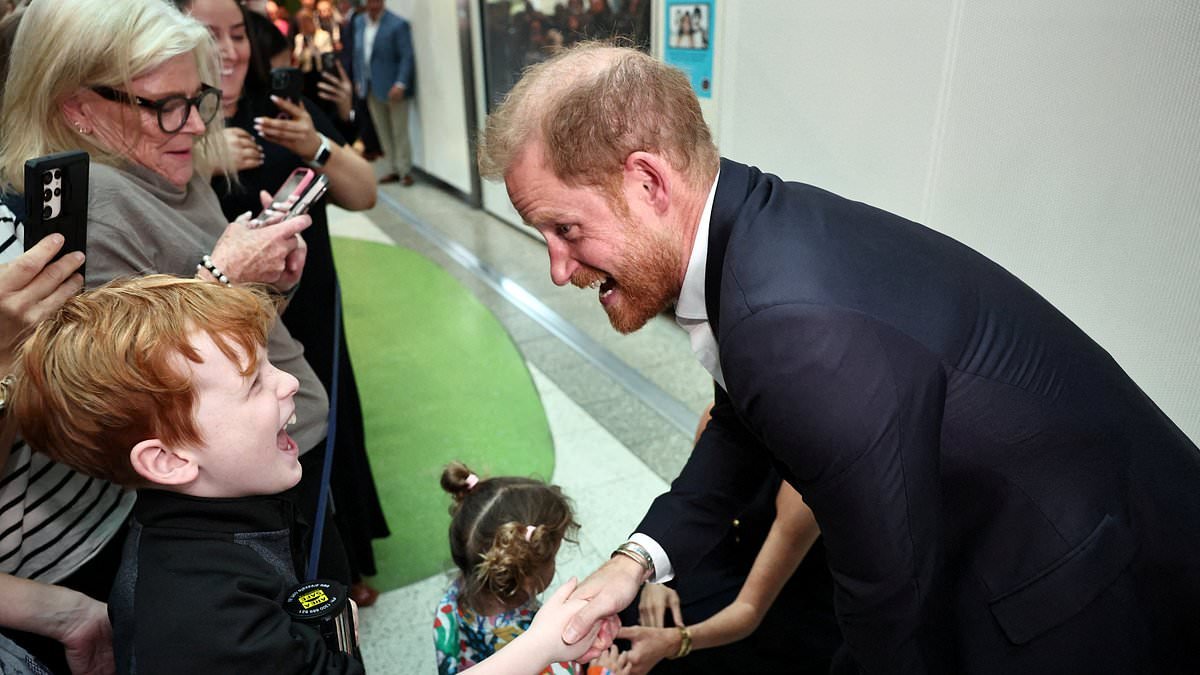 'Gingers rule!': Prince Harry can't hide his excitement after he notices young fan with fiery red hair during Melbourne hospital visit