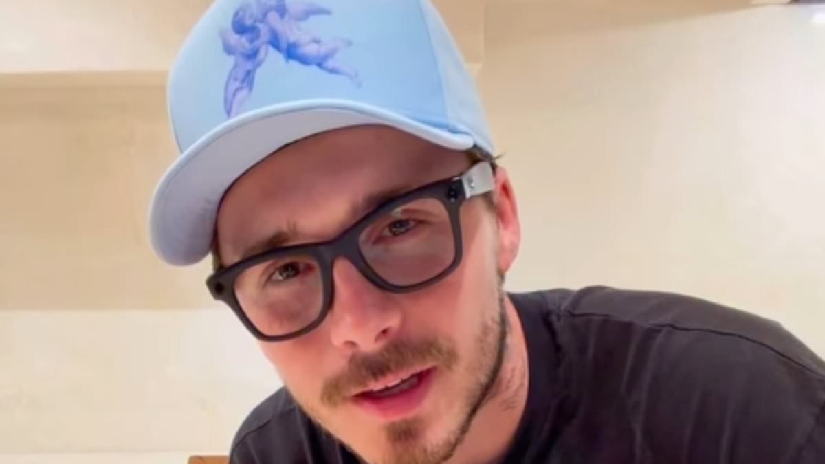 Brooklyn Brooklyn shows off a new look in cooking video as it's claimed he has 'reached out to four family members' but will still only speak to David and Victoria through lawyers