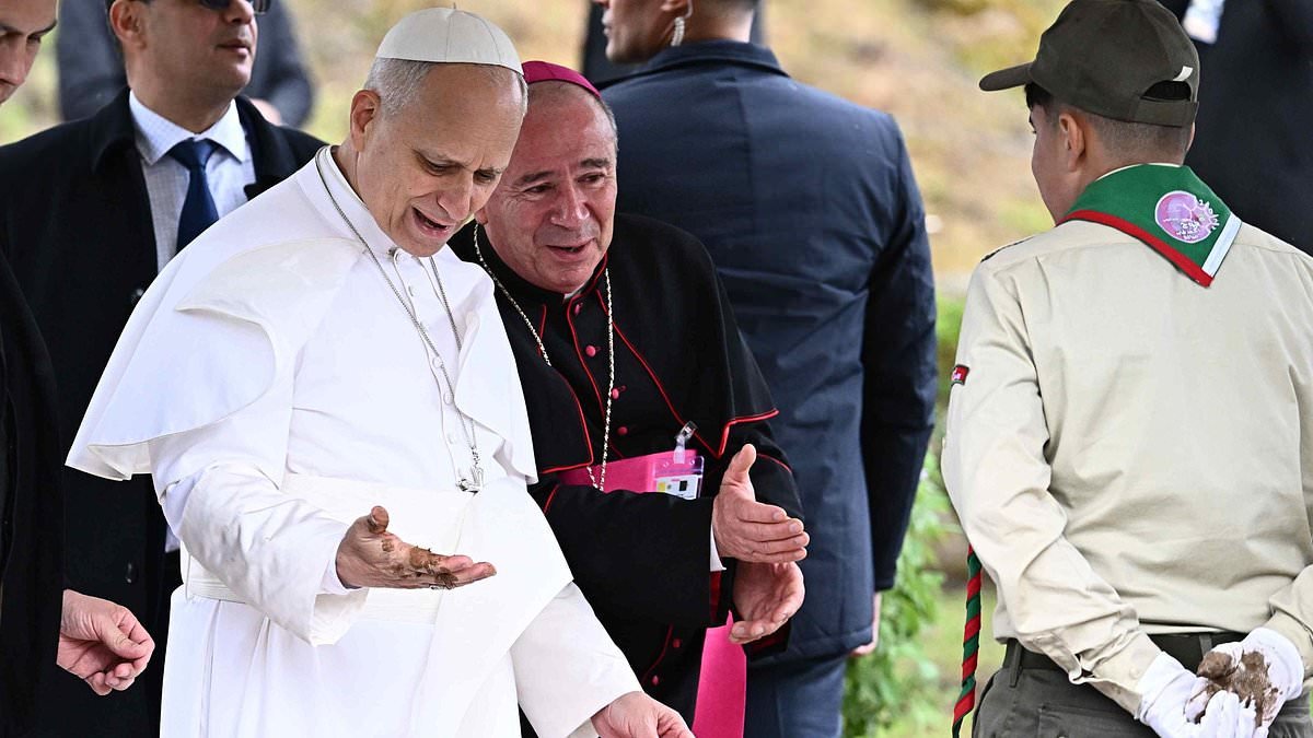The pong-tiff! Pope looks dismayed after shaking hands with boy scout and ending up covered in muck
