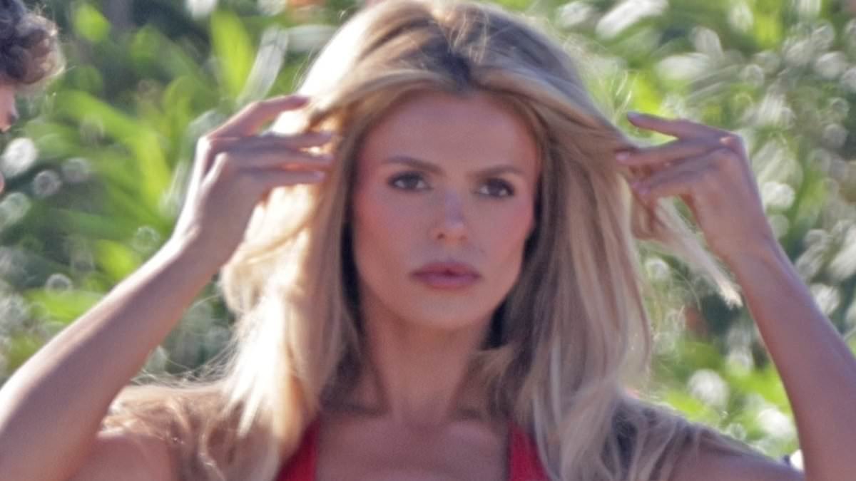 Baywatch cast brush off criticism and get back into their iconic red swimsuits to shoot beach scenes as show reboot is panned for its cast of 'influencers' with 'no acting ability'