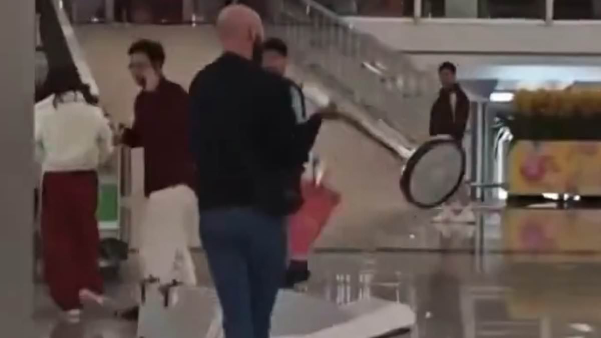 Moment Brit, 35, goes on rampage at Hong Kong airport using metal post to smash check-in desks to pieces before he is arrested for possessing Viagra
