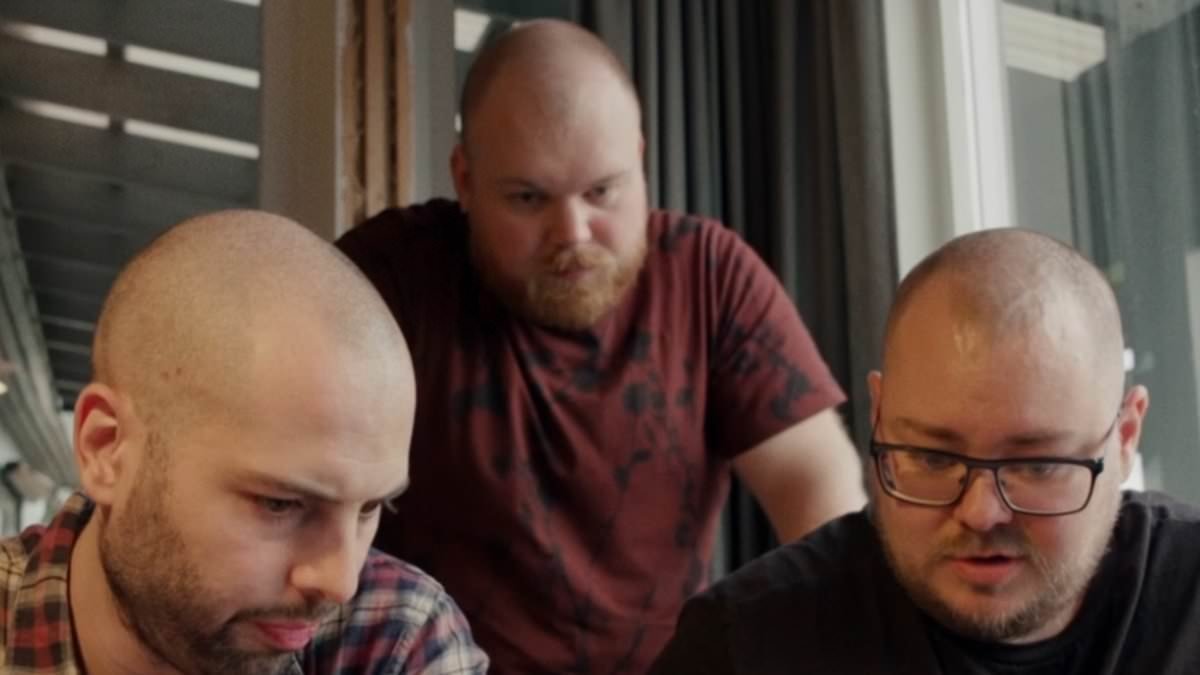 Three dads and a baby: Trio reveal how they beat the odds to have a child together - even though one is a trans man who had ovaries 'forcibly removed'