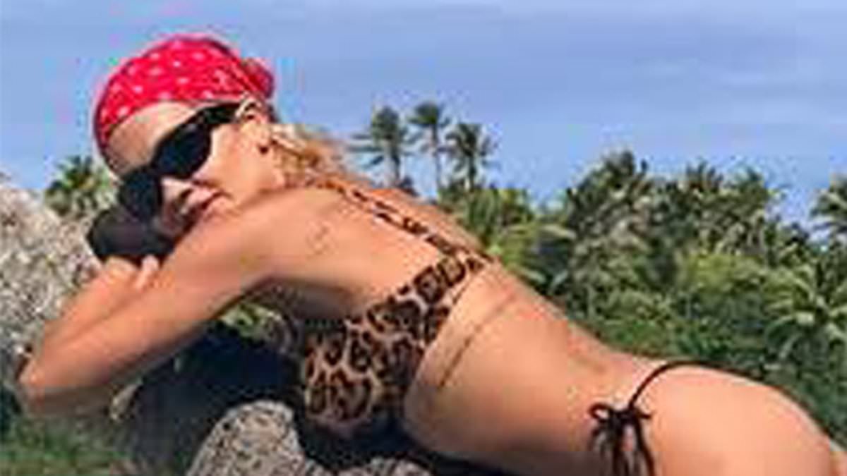 Rita Ora shows off her incredible figure in a leopard print bikini as she soaks up the sun on a paradise island break