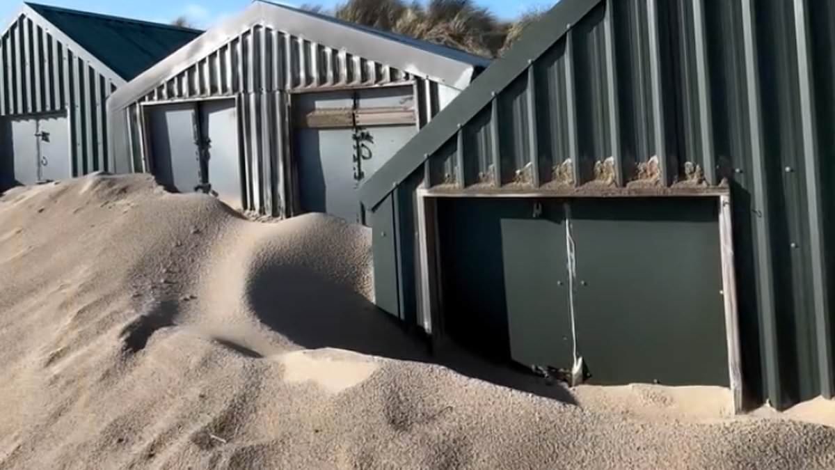 Expensive beach huts in affluent holiday hotspot dubbed 'Cheshire-on-sea' are buried under huge mountains of sand after storms