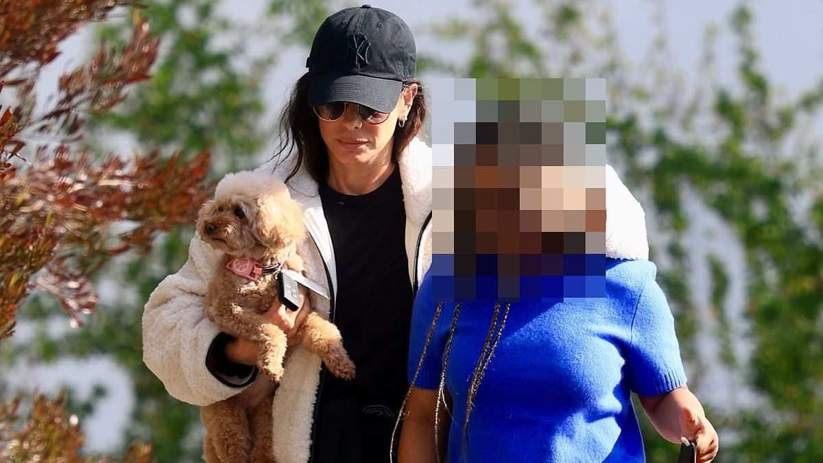 Sandra Bullock emerges on rare outing with daughter Laila, 12, who towers by her side