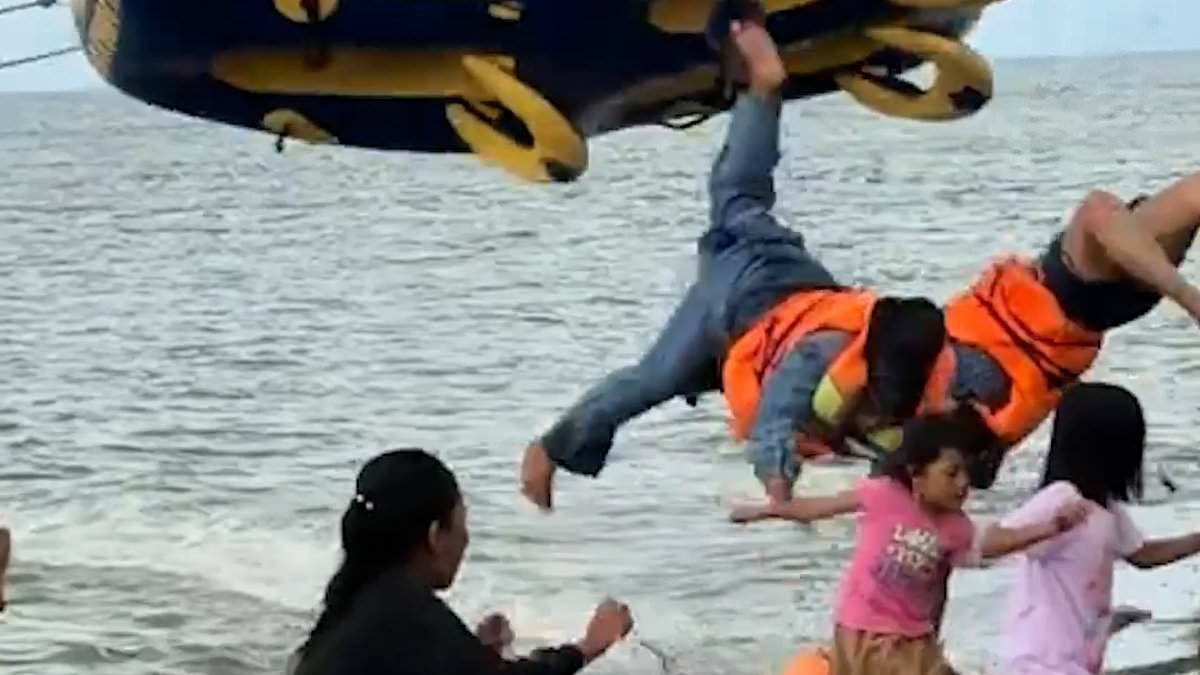 Flipping hell! Five tourists are flung through the air when 'donut boat' ride crashes into beach in Indonesia