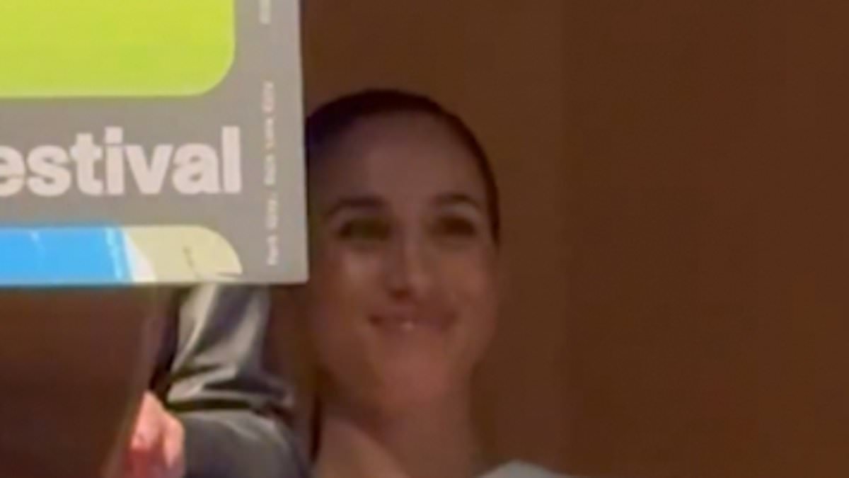 Awkward moment Meghan edges out from behind director during her speech about her Cookie Queens movie
