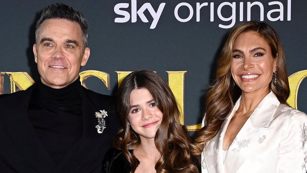 Robbie Williams says his 'talented' daughter Teddy is set to follow in his footsteps as he praises her 'wonderful voice' - but he's not bringing her on stage just yet