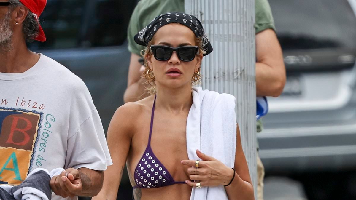 Rita Ora, 35, showcases her incredible abs in a tiny bikini top as she joins trendy husband Taika Waititi, 50, on the beach in Sydney