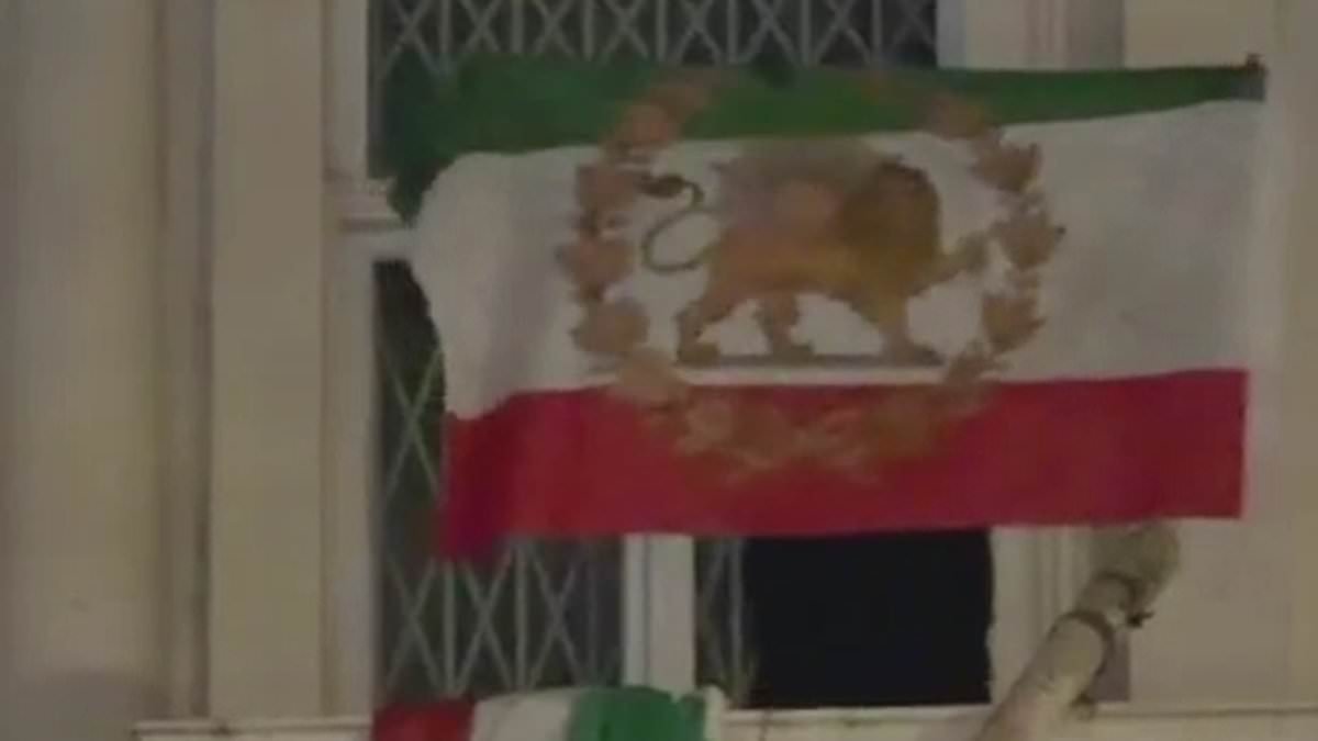 Moment protester rips down Iranian flag outside London embassy amid anti-regime protests in solidarity for Tehran