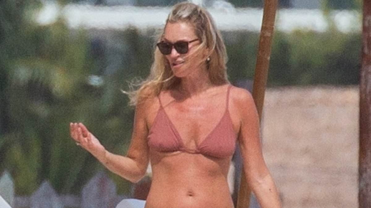 Kate Moss, 52, and her lookalike daughter Lila, 23, show off their model figures in tiny bikinis as they soak up the sun on holiday in Tulum