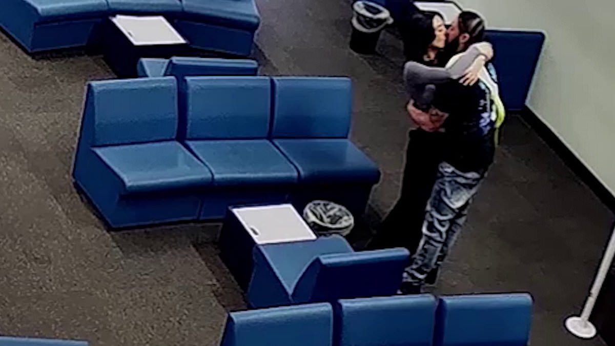 Moment probation officer kisses her convicted murderer lover while visiting him in jail