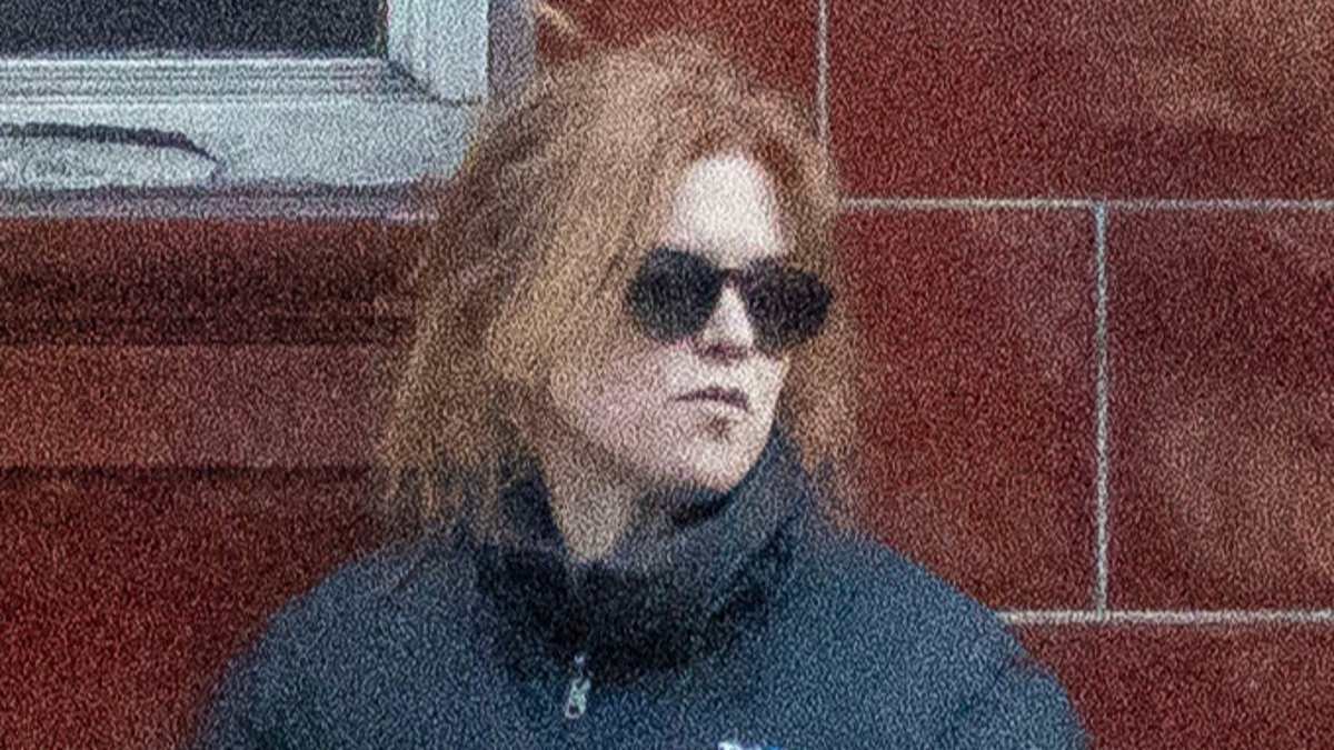 Isla Fisher wraps up warm as she walks her dog in London with her mother after 'challenging' split from Sacha Baron Cohen