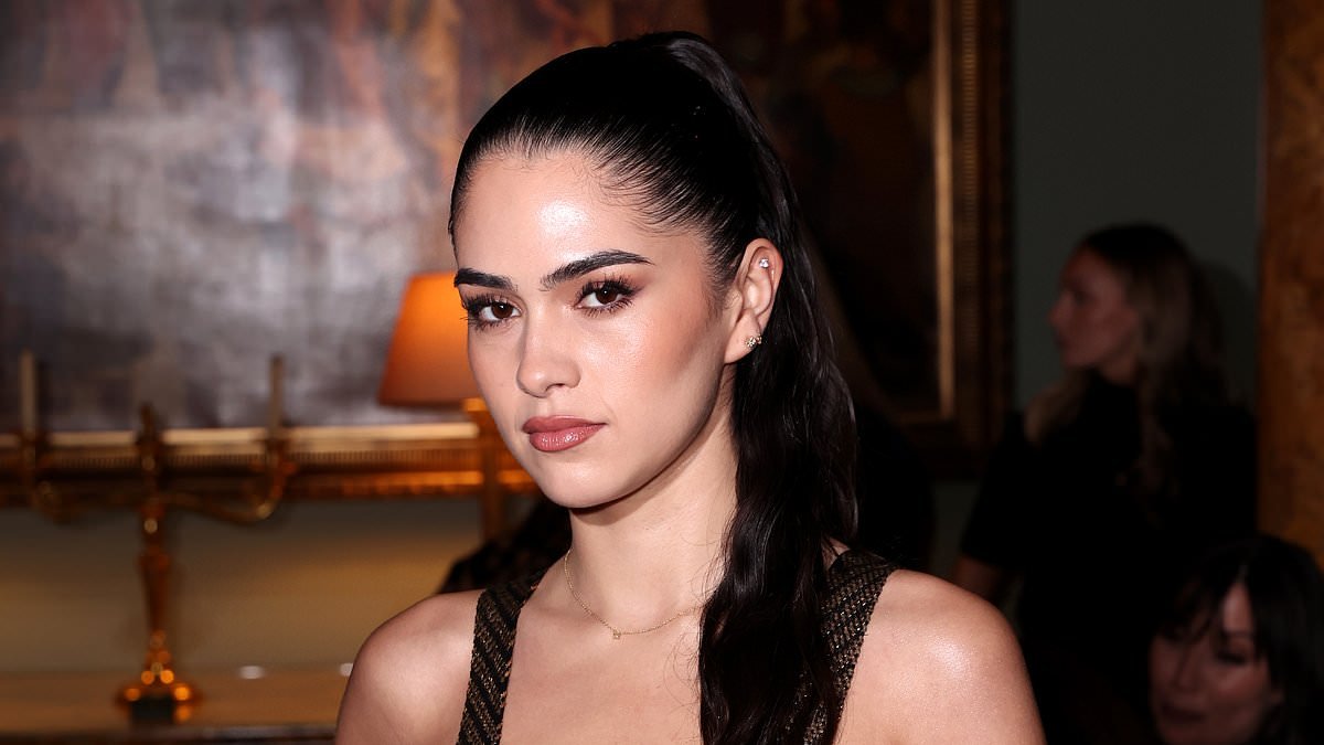 Romeo Beckham's girlfriend Kim Turnbull turns heads as she goes braless in a sheer plunging dress at Annie's London Fashion Week show amid Brooklyn family feud