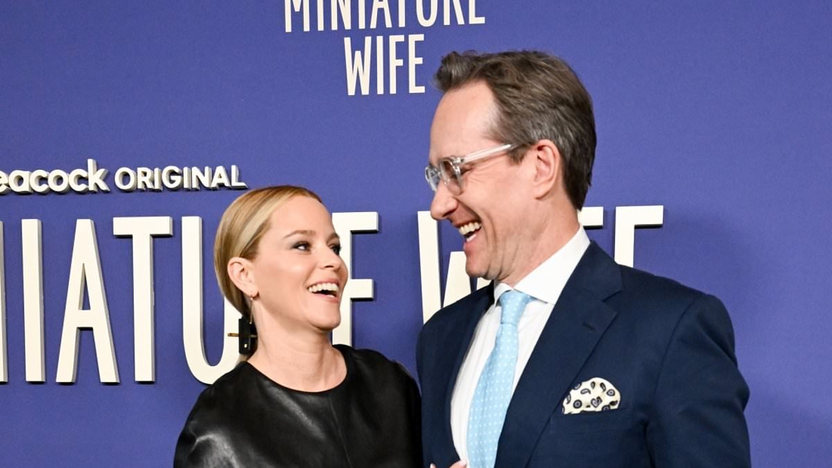 Matthew Macfadyen unveils a new look as he sports trendy specs and a loose-fitting suit while posing with screen wife Elizabeth Banks at the premiere of their new TV show