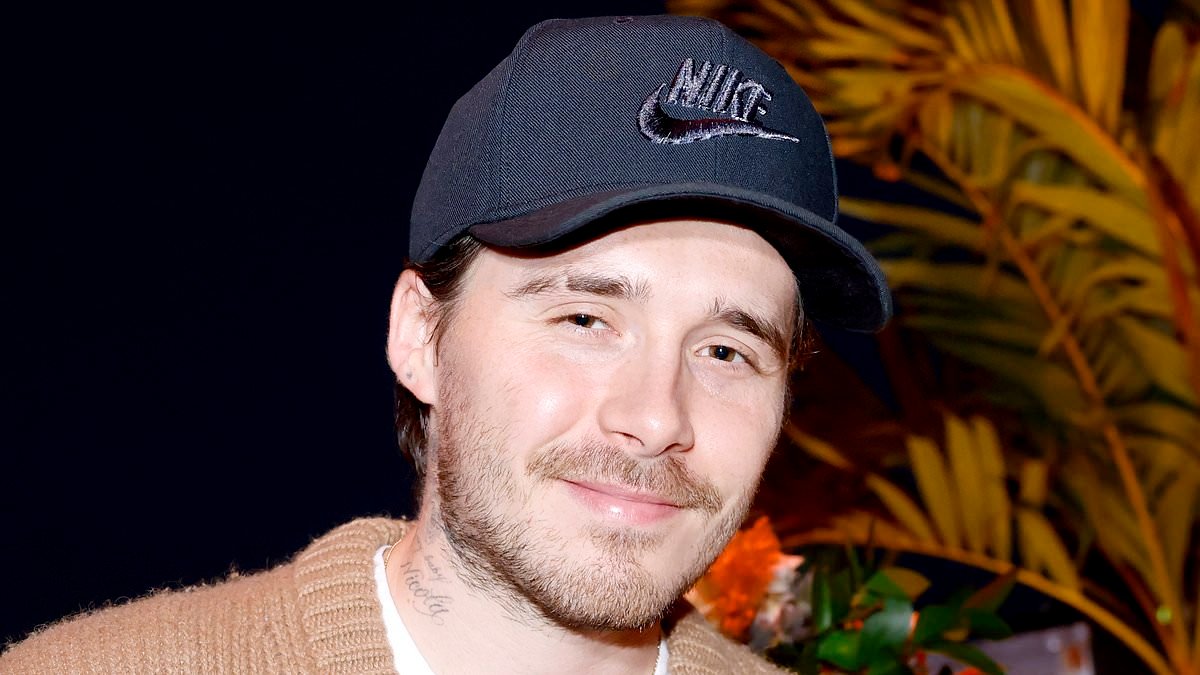 Brooklyn Beckham covers up his wrist after sporting £220k watch from estranged dad - as he prepares to miss Cruz's 21st birthday after staying in LA to plug his hot sauce