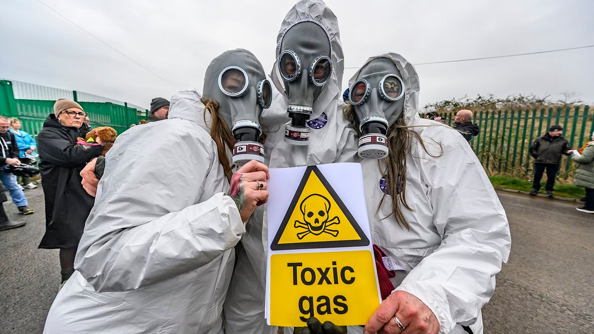 'Stop the Stink! Residents don gas masks and hazmat suits as they demand tip closure to protect children's health after spate of 'nosebleeds and breathing problems'