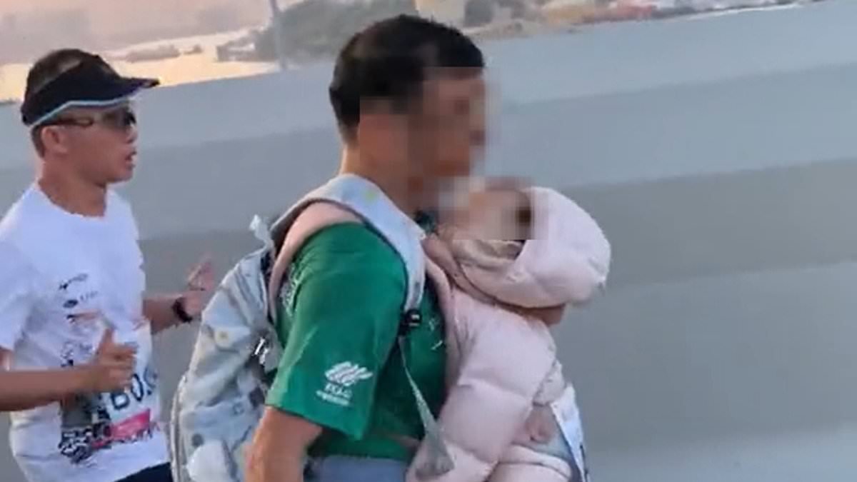 Child abuse probe after man runs marathon with a baby strapped to his chest