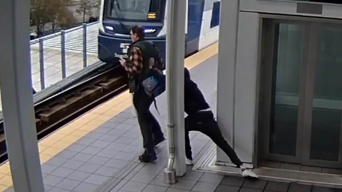 Man looking at his phone while standing on train platform suffers every commuter's worst nightmare at hands of vile stranger who was watching him from behind elevator
