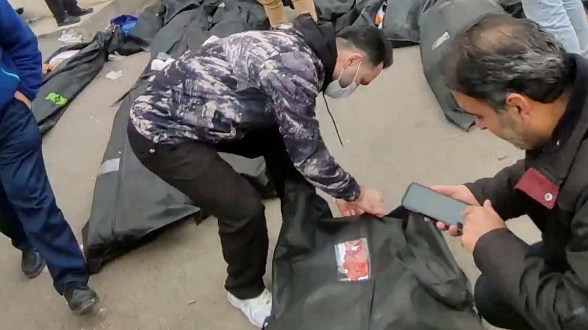 Bodies build up on streets in Iran 'after 500 protestors are killed': Mourners console each other