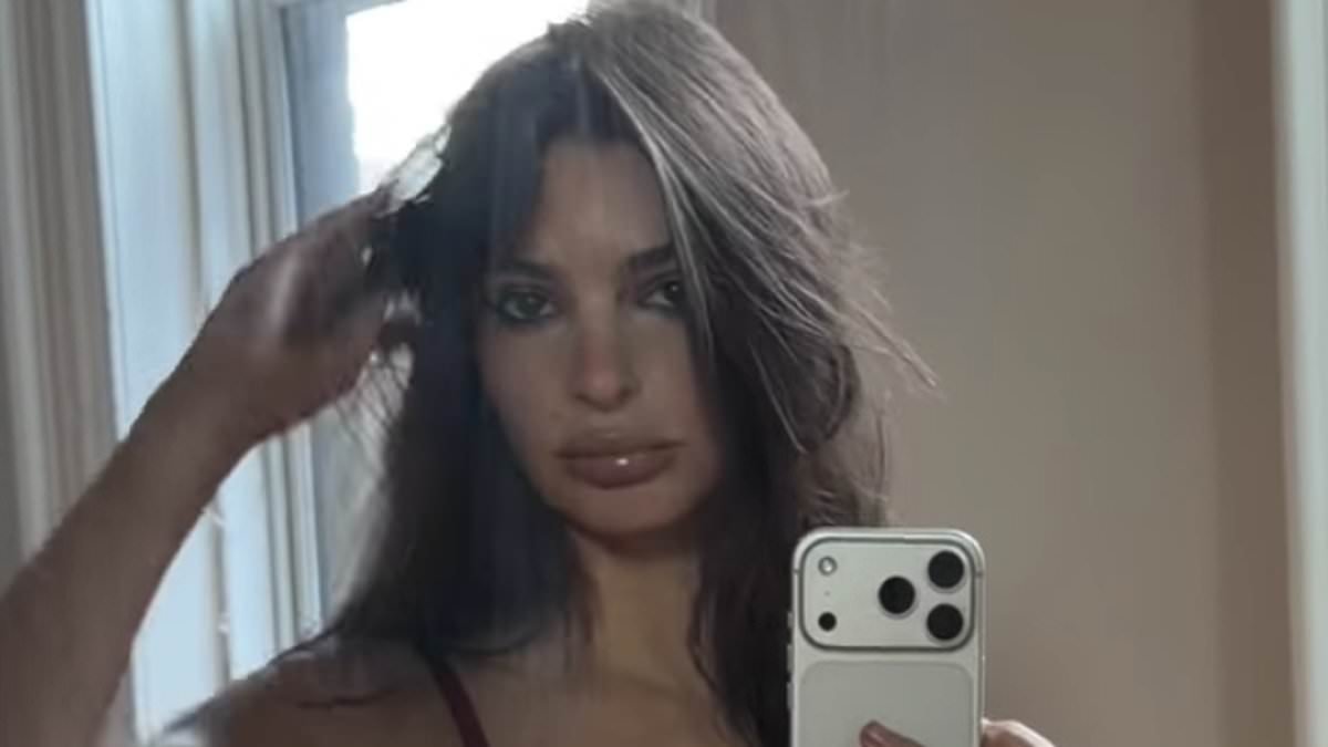 Emily Ratajkowski sends temperatures soaring as she poses in sexy red lingerie and suspenders for barefoot home shoot