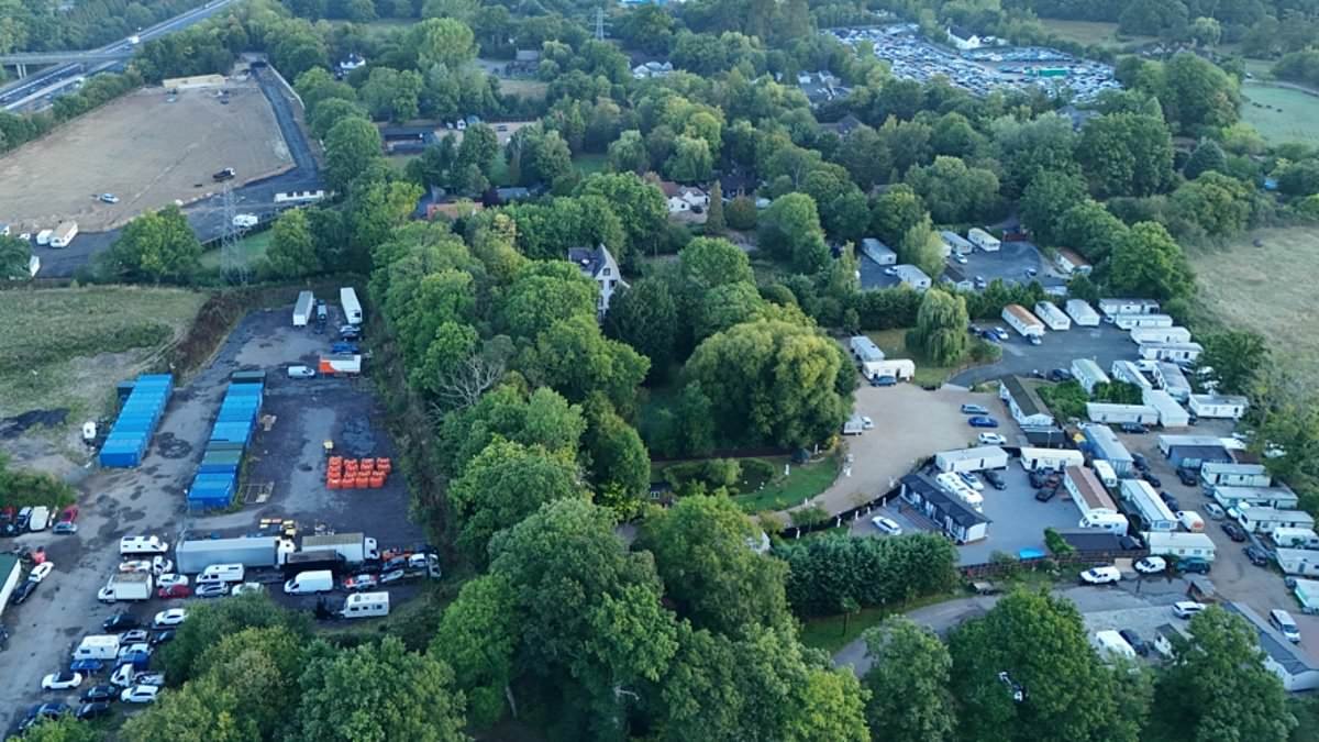 The picturesque Surrey hamlet besieged by TEN traveller sites: Millionaire homeowners 'outnumbered' as greenbelt land is paved over to make way for 70 caravans