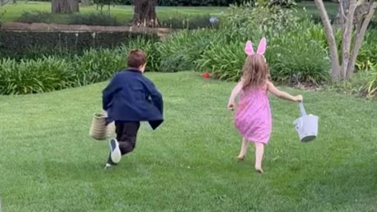 Sussexes at Easter: Meghan shares rare glimpse of Archie and Lilibet at home in US as they decorate eggs and feed chickens while royals attend Easter Sunday service in Windsor