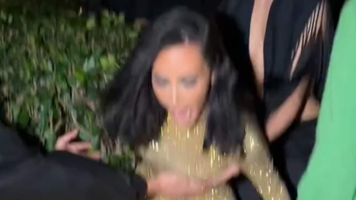 Kim Kardashian takes a VERY dramatic tumble in towering $80 'stripper heels' and accidentally grabs an 'old lady' as she falls on her way out of Vanity Fair Oscars party