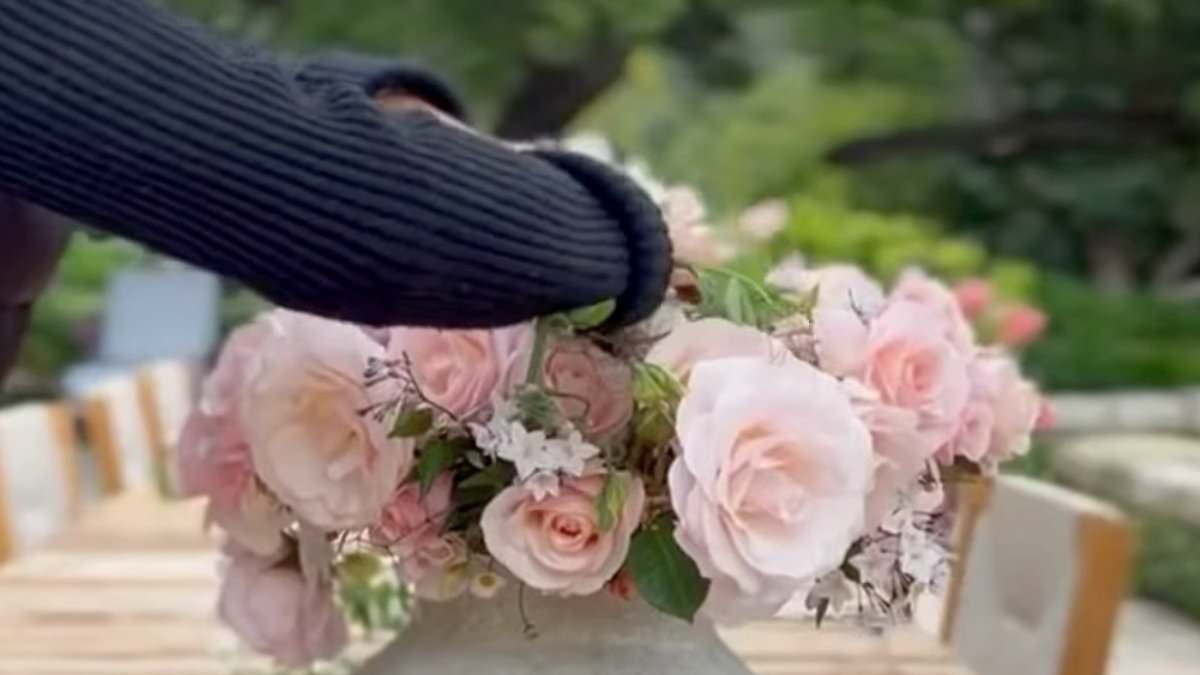 Prince Harry praises Meghan Markle's flower arranging and calls her 'babe' in new family videos showing a glimpse of Lilibet's flowing red hair