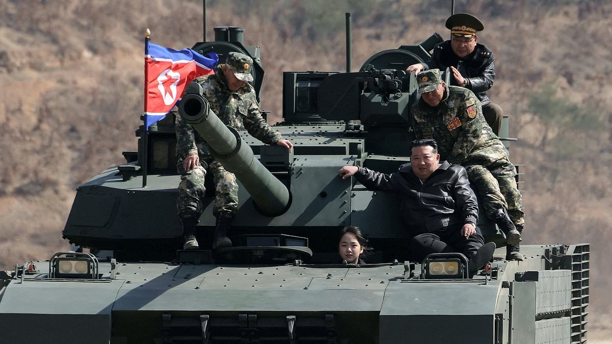 Steering his successor: North Korean dictator Kim Jong Un watches on with pride as his daughter, 13, sits behind the wheel of a tank during a military drill